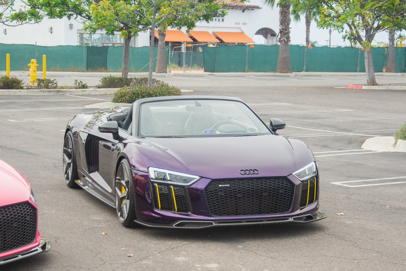 Audi R8 V10 Spyder with an Avalanche Design dry carbon fiber front lip splitter, roof down and sculpted front corners visible from a front three quarter angle