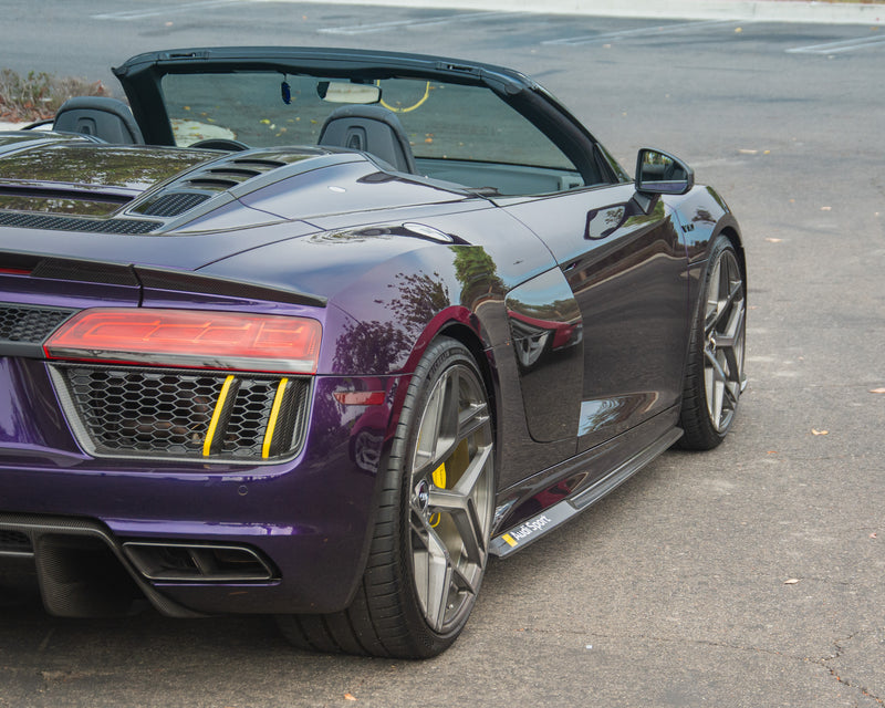 Audi R8 V10 Spyder Gen 2 with the roof down, rear three quarter view emphasizing its wide stance and sculpted bodywork