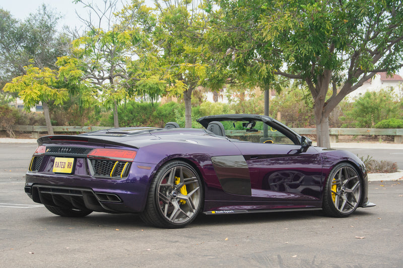 Audi R8 V10 Spyder Type 4S with the roof down, low stance and sculpted rear shoulders in a rear three quarter profile